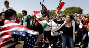  A Mexican-American student (left) is bullied by nationalist students for carrying the American flag while showing support of immigrant rights. When do you feel that use of national flags and symbolisms become excessive and unsavory? Have you ever felt “anti-flag?”
